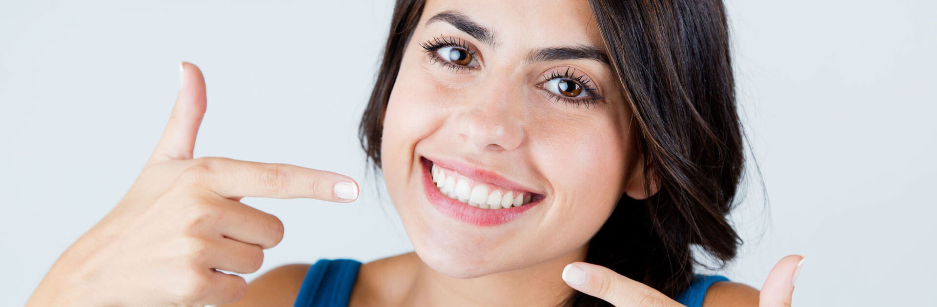 Woman pointing at her teeth