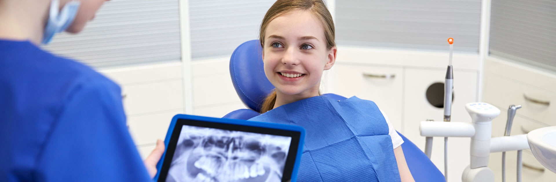 Dentist with teeth x-ray on tablet pc computer